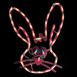 A pink window silhouette decoration for Easter. Designed to look like a cute bunny head with blue eyes and a red nose