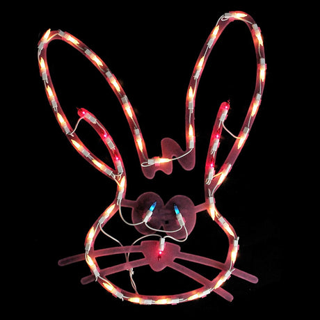 A pink window silhouette decoration for Easter. Designed to look like a cute bunny head with blue eyes and a red nose