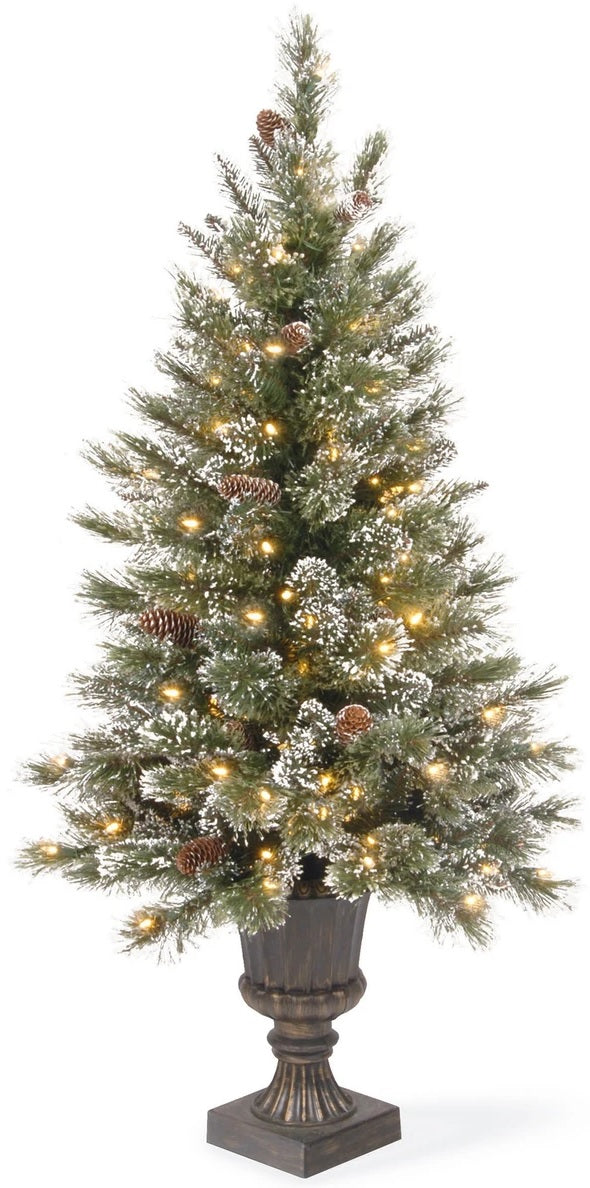 Pre-lit tree in a pot. The branches are covered in white glitter and there are pine cone accents. The lights are clear.