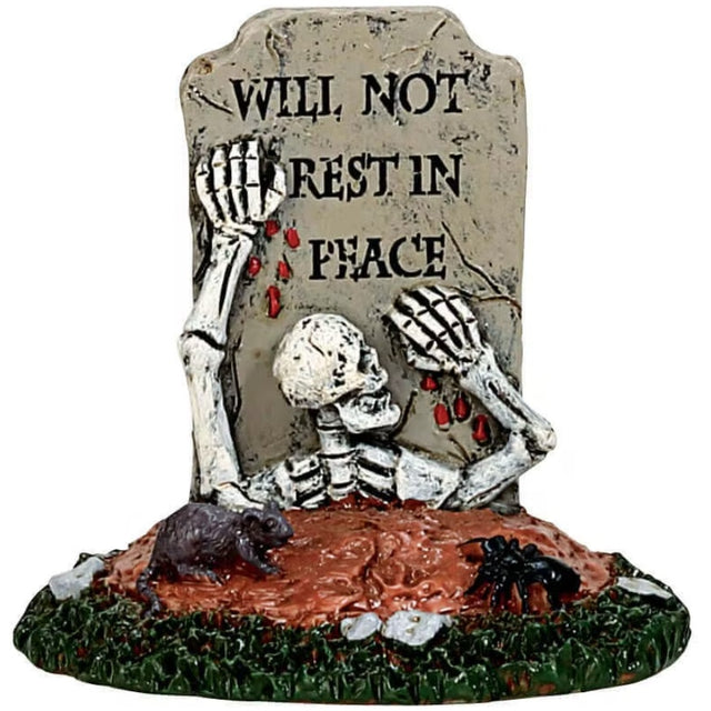 Polyresin village accessory for a Spooky Town Lemax display. Designed to look like a skeleton crawling out of a grave. The tombstone reads "WILL NOT REST IN PEACE." There's a rat and a large, black spider nearby.