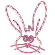 A pink window silhouette decoration for Easter. Designed to look like a cute bunny head with blue eyes and a red nose