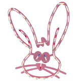 A pink window silhouette decoration for Easter. Designed to look like a cute bunny head with blue eyes and a red nose