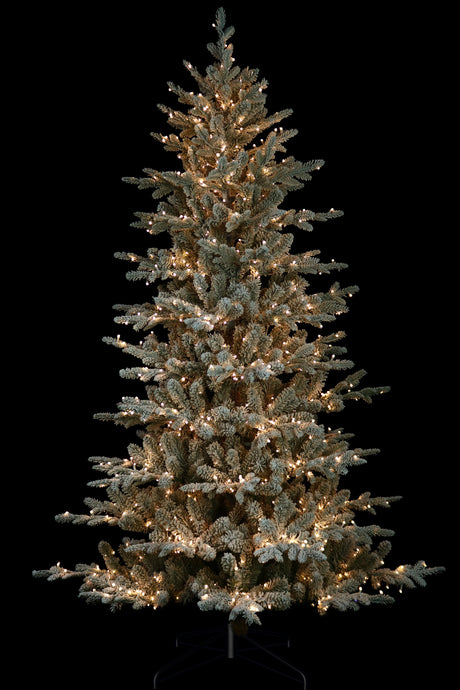 Artificial tree pre-lit with Starry lights. Branches are covered in white to appear covered in snow.