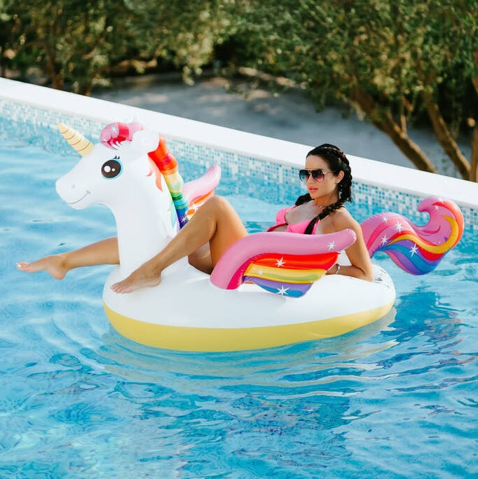 Inflatable pool float shaped like a rainbow unicorn.