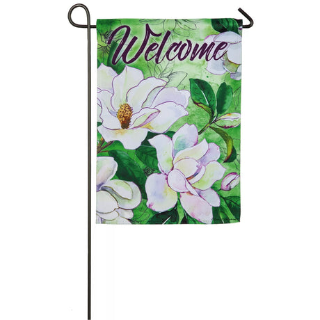 A green flag that reads "WELCOME" and features a bunch of white flowers with green stems