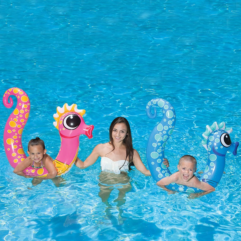 Pool inflatables shaped like seahorses. One is pink and one is blue.
