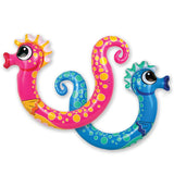 Pool inflatables shaped like seahorses. One is pink and one is blue.