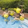 Yellow beach balls designed to look like different emojis.