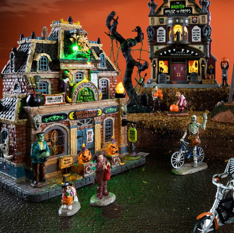 Porcelain building for a Lemax display. Designed to look like a brick museum accented with owls, flames, carved pumpkins, witch hats, ghosts and Frankenstein.