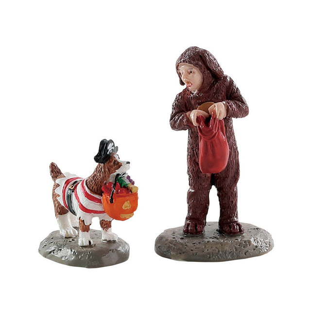 Polyresin figurines for a Lemax display. Designed to look like a young child and a dog trick or treating. The child is dressed as a dog and the dog is dressed as a pirate.