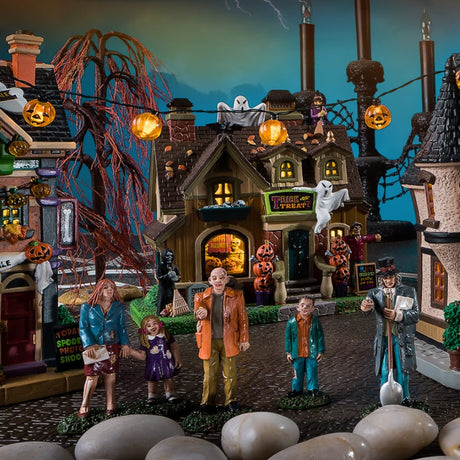 Porcelain house for a Lemax display. Designed to look like a house that's been decorated for Halloween. There are ghosts, witches, carved pumpkins and tombstones.