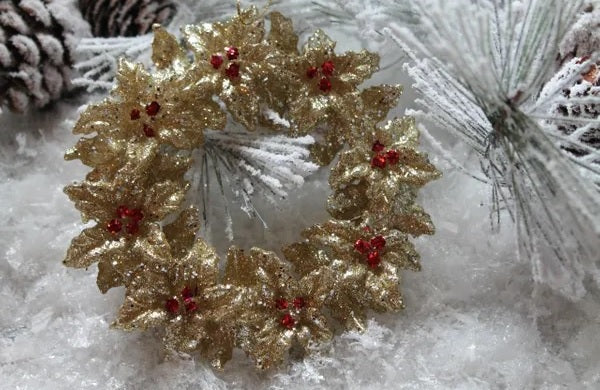 Gold glitter ornament shaped like a wreath with red berry accents.