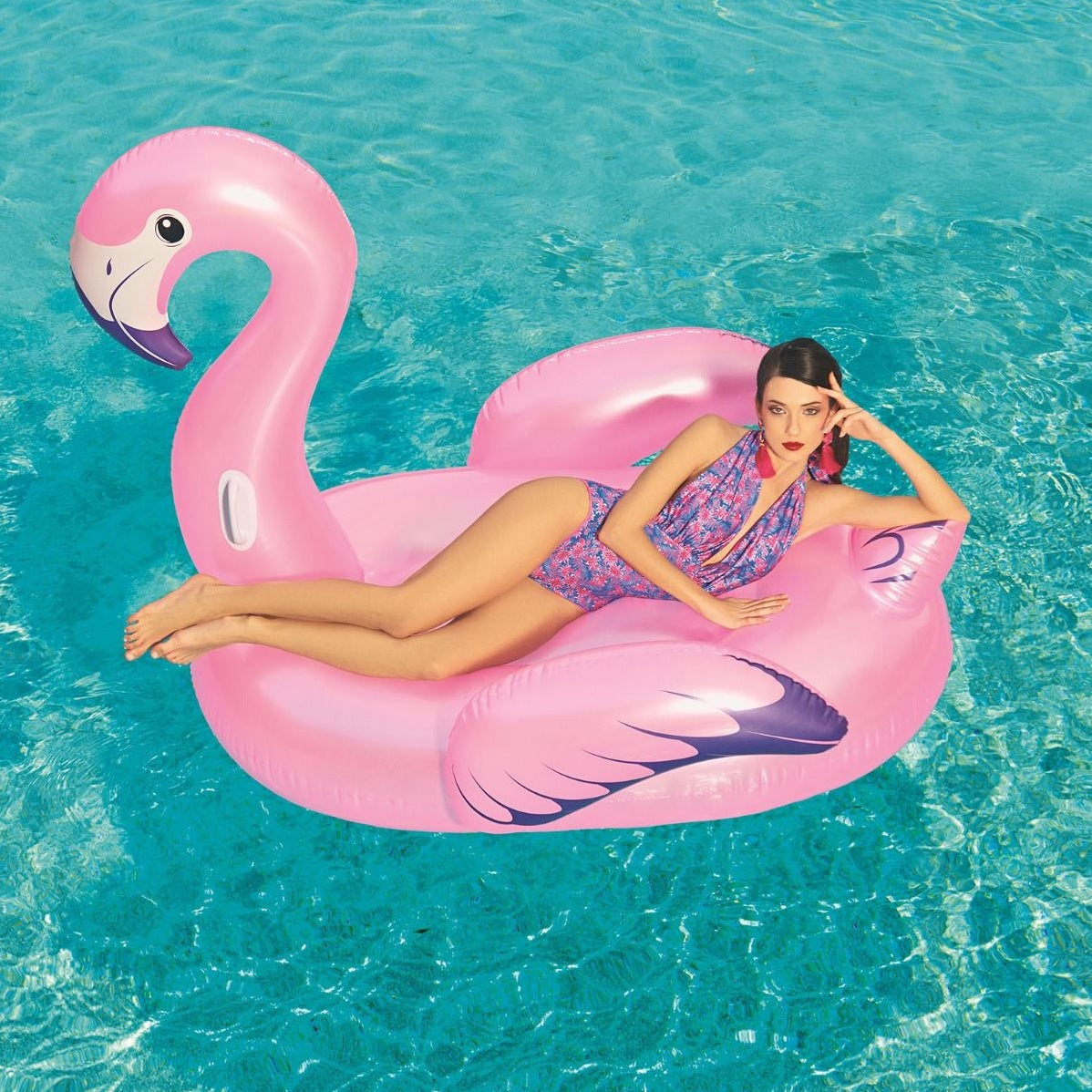 Ride on pool inflatable shaped like a pink flamingo.