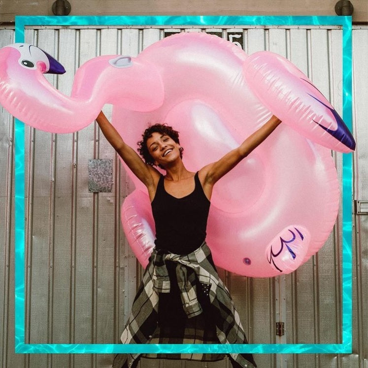 Ride on pool inflatable shaped like a pink flamingo.