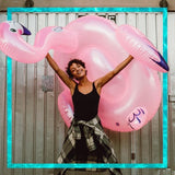 Ride on pool inflatable shaped like a pink flamingo.