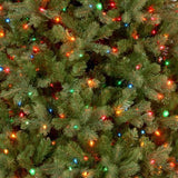Artificial tree pre-lit with multi-colored lights.