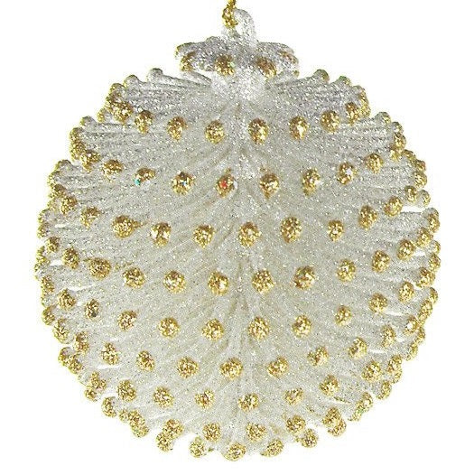 Glitter ornaments shaped like round pine cones. One is silver with gold tips and the other is gold with silver tips.