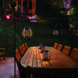 This is a lifestyle image showing the lanterns being used in a backyard at night.