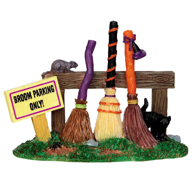Polyresin village accent for a Lemax display. Designed to look like a wooden fence with three broomsticks leaning up against it. There's a sign that reads "BROOM PARKING ONLY!" And there's a rat on the fence and a black cat underneath it.