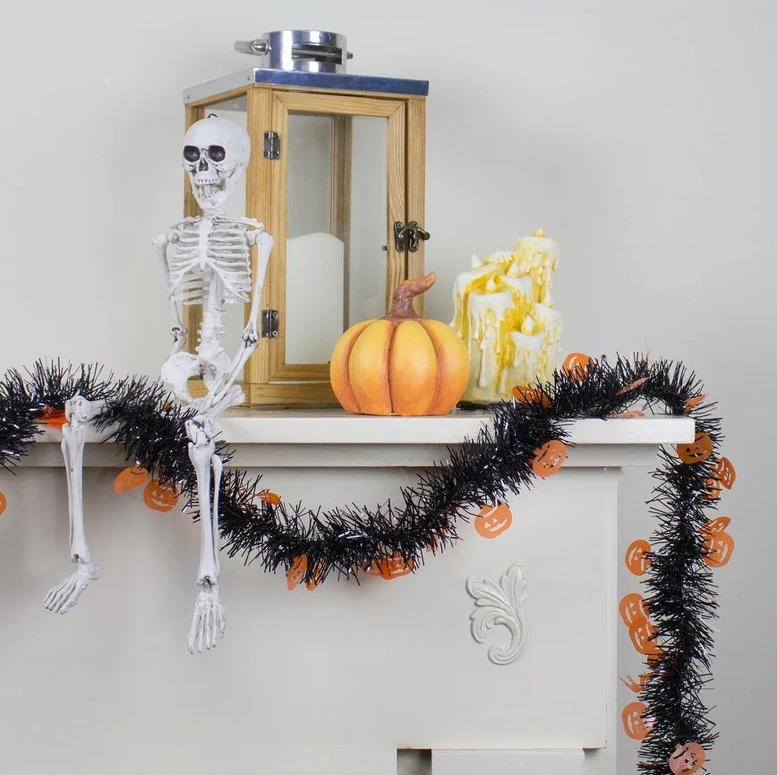 Black tinsel garland with holographic, orange pumpkins.