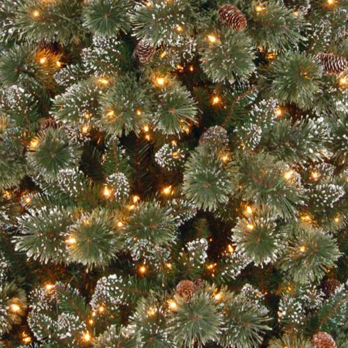 Artificial tree pre-lit with dual lights. Lights change from warm white to multi-colored. Branches are covered in white glitter.