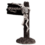 Polyresin figurine for a Lemax display. Designed to look like a sign that reads "SPOOKY TOWN THIS WAY!" There's a skeleton hanging from the sign.