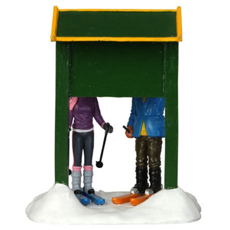 Polyresin figurine for a Lemax display. Designed to look like two people on skis looking at a run map for Vail Village. They're both wearing winter clothes and the ground is covered in snow.