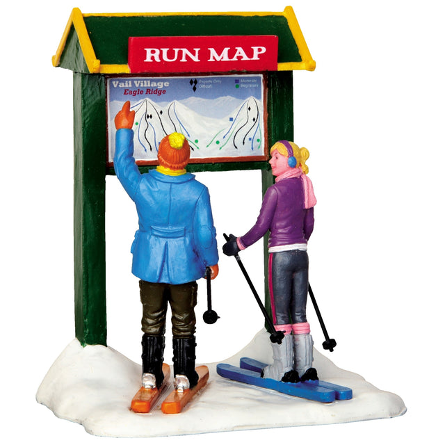 Polyresin figurine for a Lemax display. Designed to look like two people on skis looking at a run map for Vail Village. They're both wearing winter clothes and the ground is covered in snow.