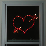 Lighted silhouette decoration shaped like a heart with an arrow through it.