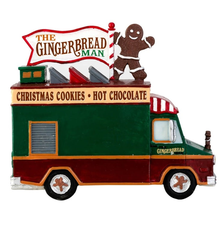 Village accent for a Lemax display. Designed to look like a food vendor truck that serves cupcakes, hot cider and gingerbread. There's a dog waiting patiently for a free sample.