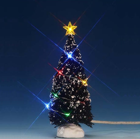 Lemax village accessory designed to look like a snow-covered tree that has multi-colored lights on it and a yellow star on top.