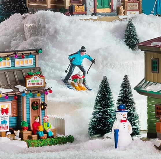 Village figurine for a Lemax display. Designed to look like a dad and son skiing down a hill together.