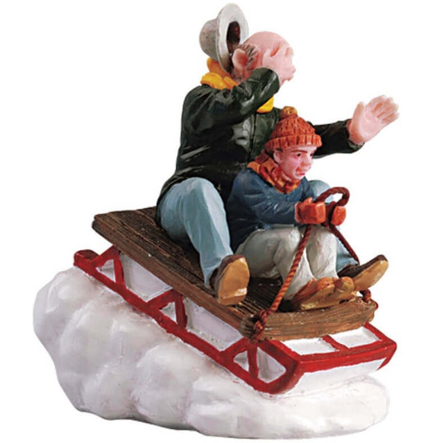 Polyresin figurine for a Lemax display. Designed to look like a young boy directing a sled with his Grandpa behind him. Grandpa's hat is about to fly off. The sled is going down a snowy hill.