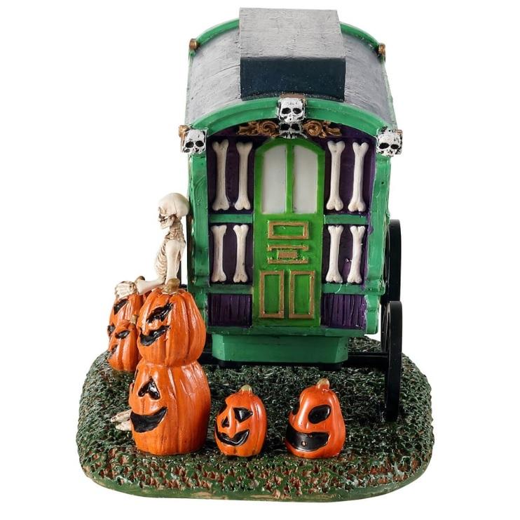 Polyresin village accent for a Lemax display. Designed to look like a green, purple and red cart that reads "PUMPKIN FESTIVAL." There are jack-o-lanterns on the ground and a skeleton standing next to the cart.