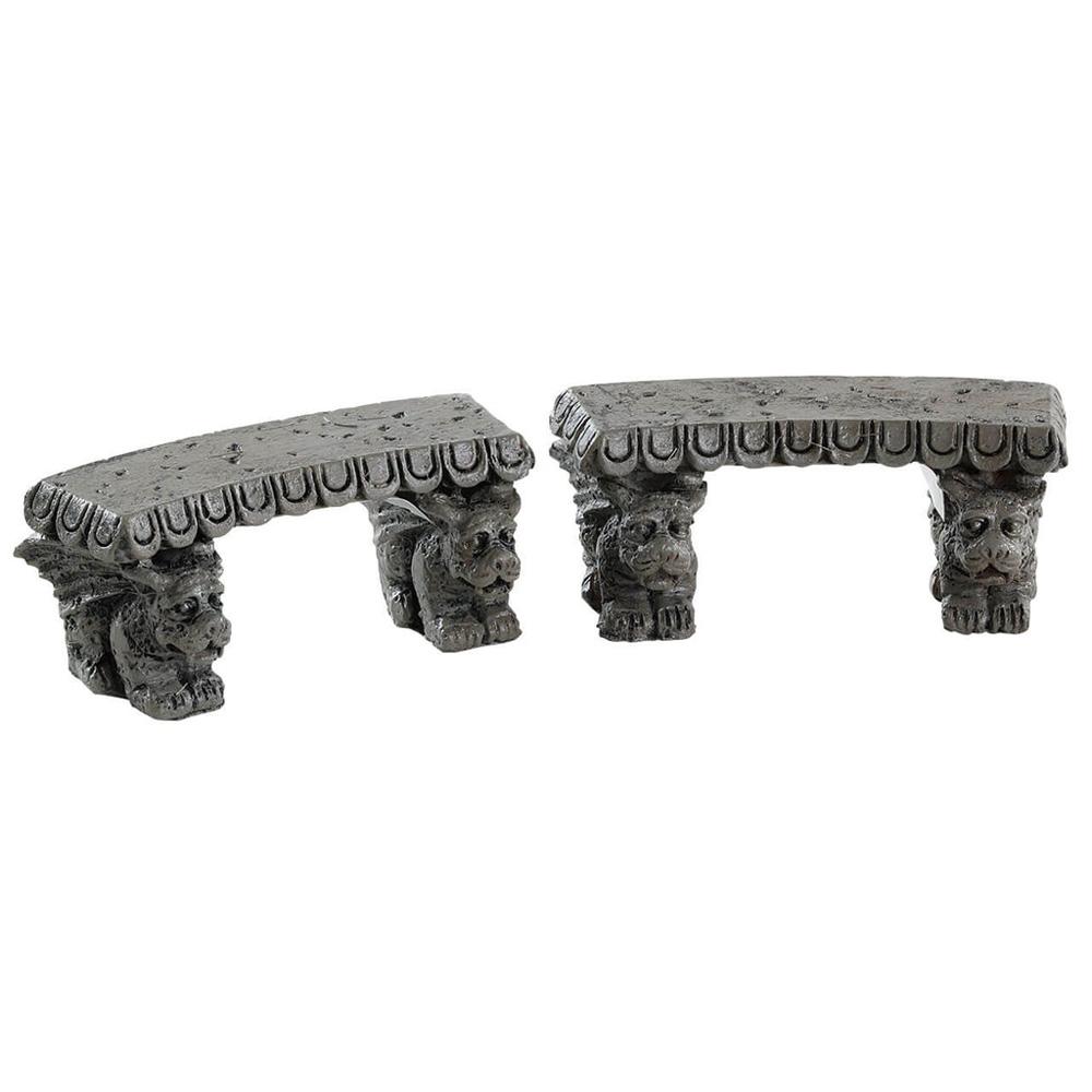 Polyresin figures for a Lemax display. Designed to look like two stone benches. The legs of the benches are shaped like gargoyles.
