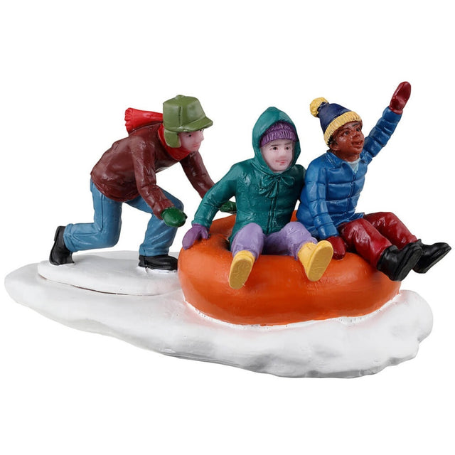 Resin figurine for a Lemax display. Designed to look like two children in an inner tube and another child behind them pushing them down a hill in snow.