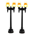 Plastic village accessories for a Lemax display. Designed to look like two shiny, black lampposts with candy corn shaped light bulb covers.