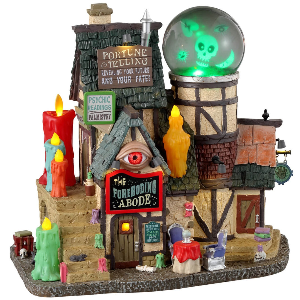 Resin lighted building for a Lemax display. Designed to look like an old-timey cottage. There are colorful candles everywhere. There's an eye above the front door and a giant crystal ball on the roof with a skull, an eye, a broken heart and a moon inside. There's a table outside with two chairs and a crystal ball on the table.