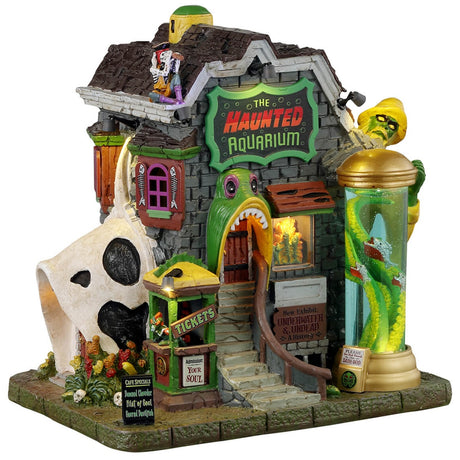 Resin lighted building for a Lemax display. Designed to look like a really unique Haunted Aquarium. There's a giant glass column outside with a monster with tentacles inside. There's a monster sitting on the roof. The front door is a monster with its mouth open. There's a ticket booth outside the front door.