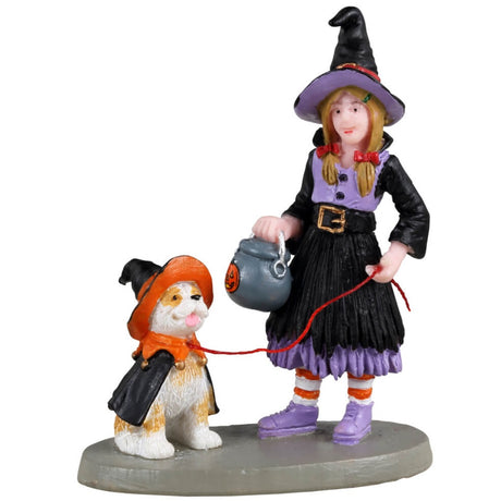 Resin figurine for a Lemax Spooky Town display. Designed to look like a young girl dressed as a witch. She's walking her dog who is also wearing a witch costume. 