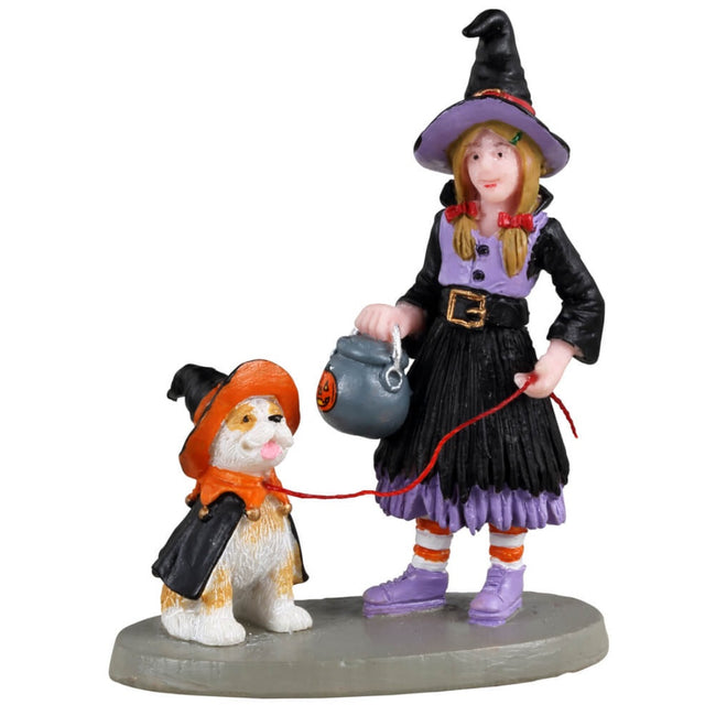 Resin figurine for a Lemax Spooky Town display. Designed to look like a young girl dressed as a witch. She's walking her dog who is also wearing a witch costume. 