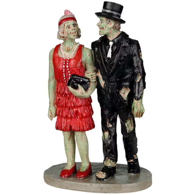 Resin figurine for a Spooky Town Lemax display. Designed to look like a monster couple all dressed up. The woman is wearing a red flapper dress with a pearl necklace. The man is wearing a ratty, old black suit with a black top hat.