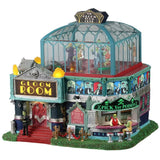 Resin lighted building for a Lemax Spooky Town display. Designed to look like an art deco themed dance club. There's a red carpet and a red velvet rope. There's a bar on the outside that reads "x PICK YER POISON x." There's a monster behind the bar and a woman sitting on a stool. There's a glass dome on top where you can see all the people dancing inside.