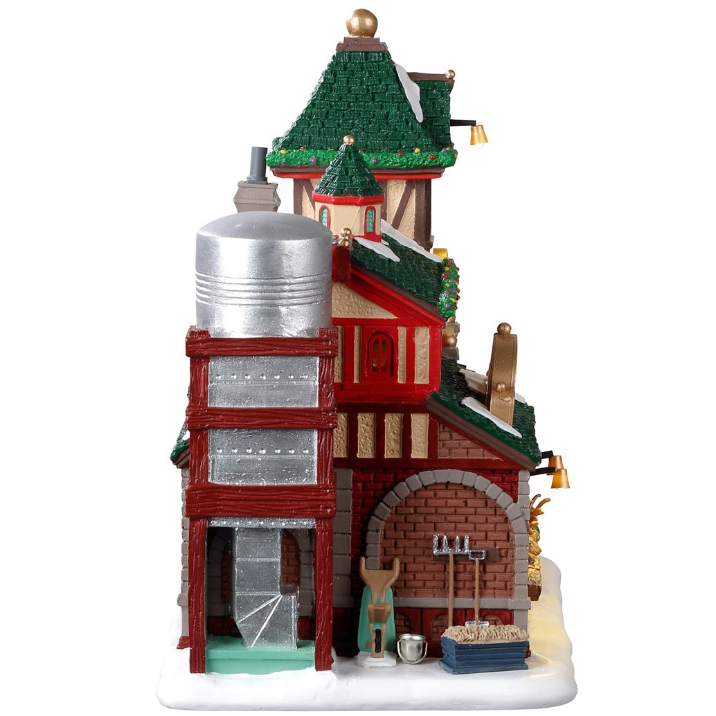 Resin lighted building for a Lemax display. Designed to look like Santa's Reindeer Stables. There are reindeer eating and elves helping Santa Claus get his sleigh ready.