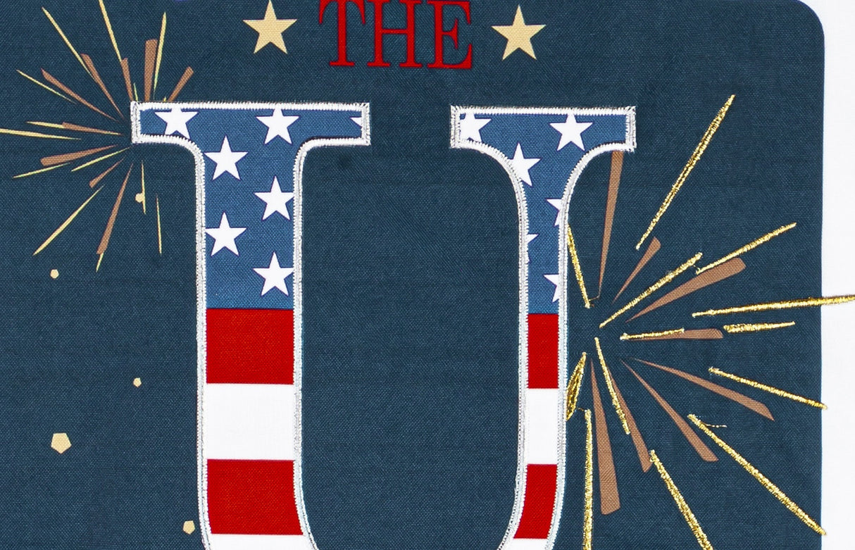 Sign that reads "GOD BLESS THE USA." The background is blue with yellow, white and orange fireworks. The USA is decorated to look like the American flag.