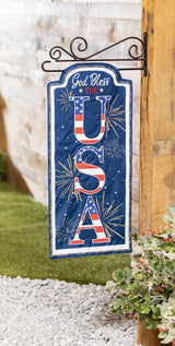 Sign that reads "GOD BLESS THE USA." The background is blue with yellow, white and orange fireworks. The USA is decorated to look like the American flag.