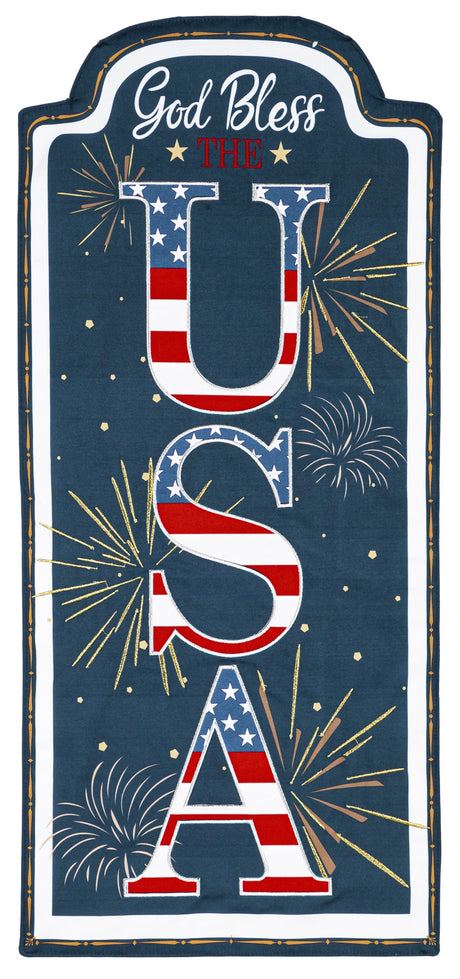 Sign that reads "GOD BLESS THE USA." The background is blue with yellow, white and orange fireworks. The USA is decorated to look like the American flag.