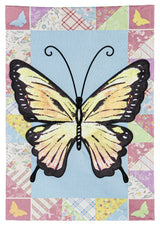 A flag featuring an Ornythion Swallowtail Butterfly. The background of this flag consists of different looking and different colored materials. Colors include: red, pink, yellow, light blue, lime green and orange