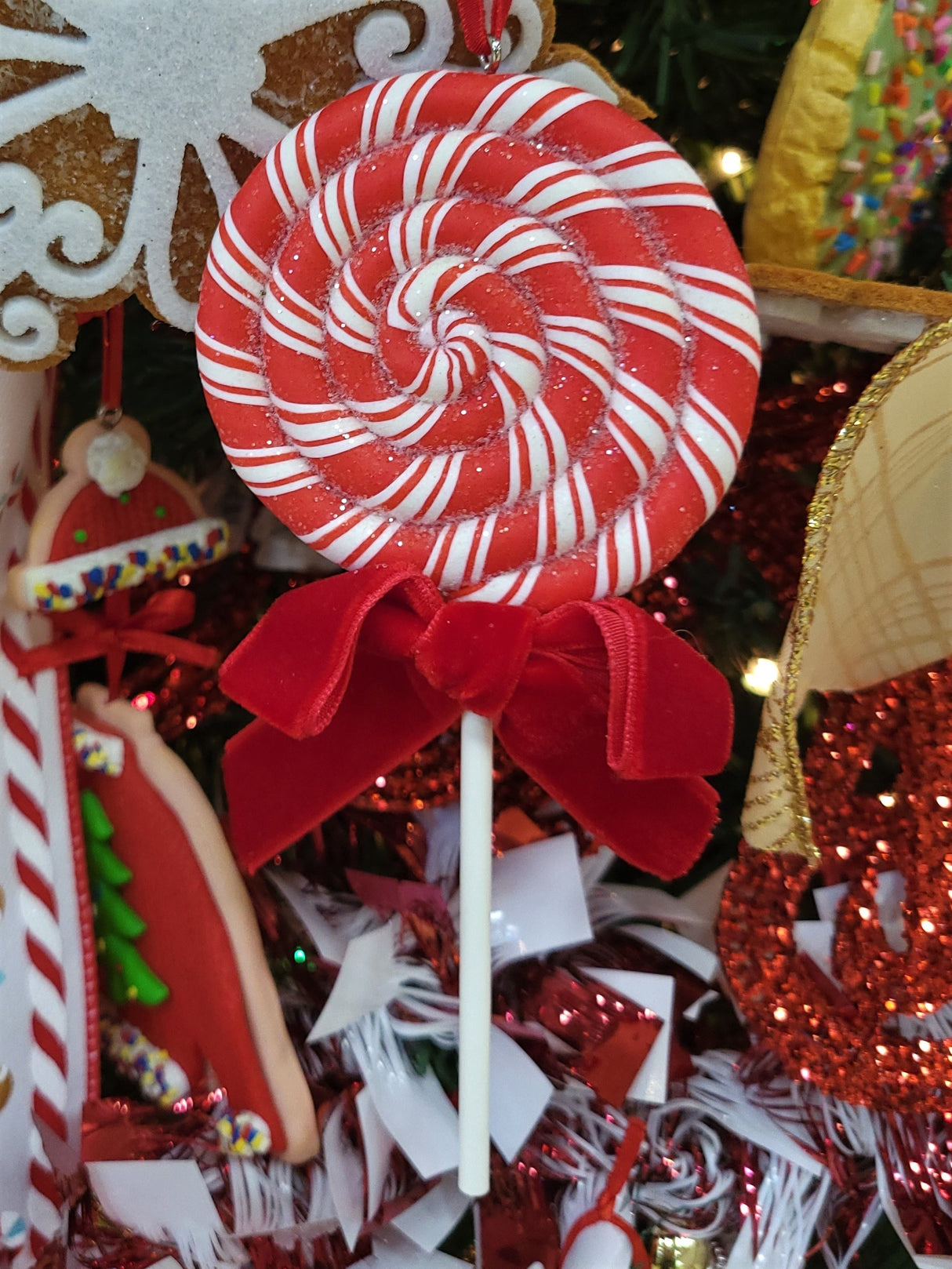 Ornaments shaped like red and white peppermint lollipops.