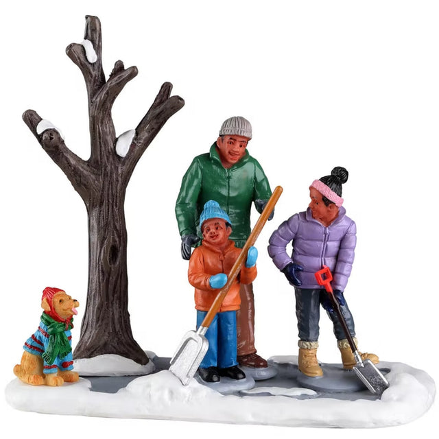 Resin table accent for a Lemax display. Designed to look like a dad and two of his young children shoveling snow away from a tree. There's a yellow dog wearing a sweater and a hat.